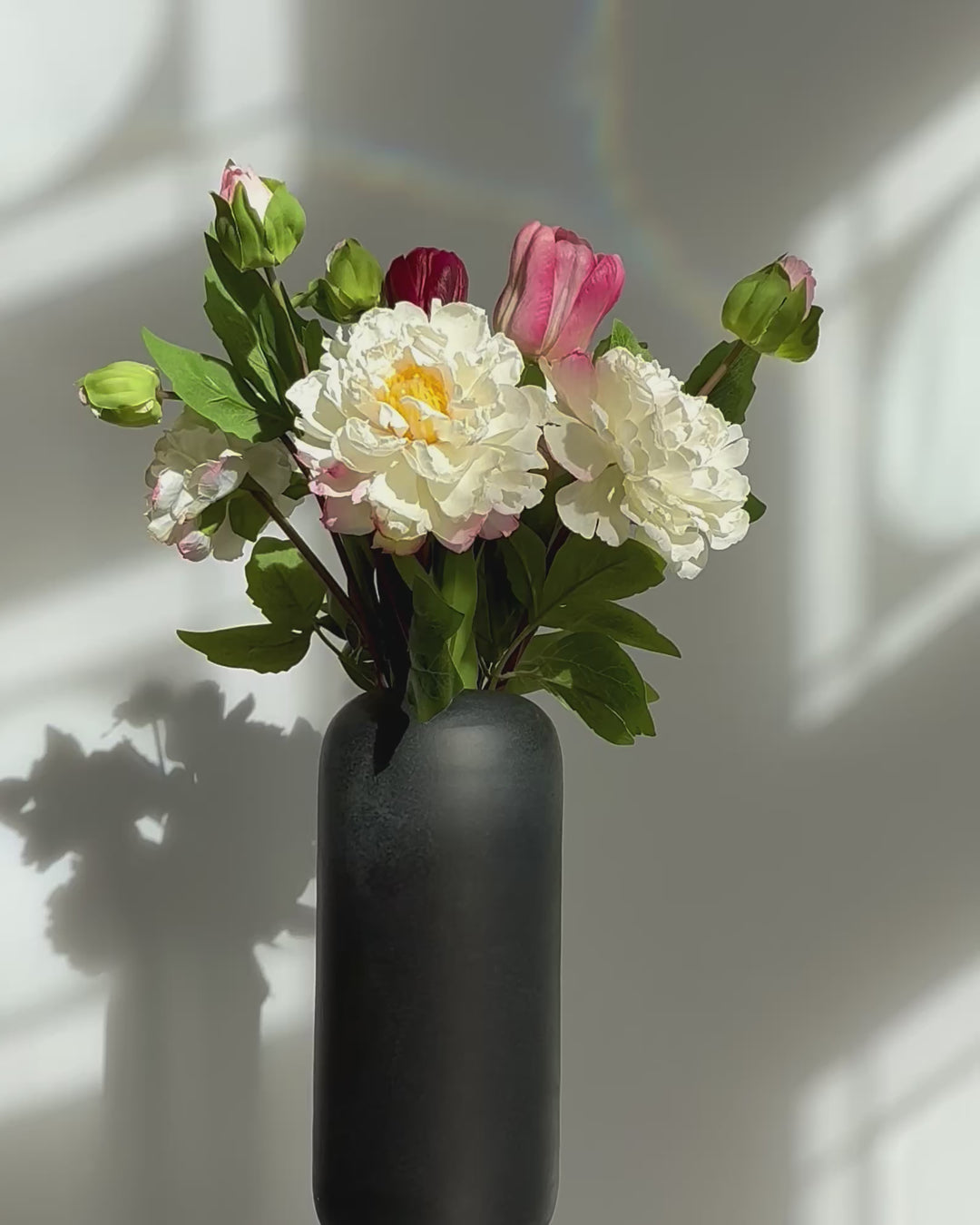 Peony, tulips in a black base